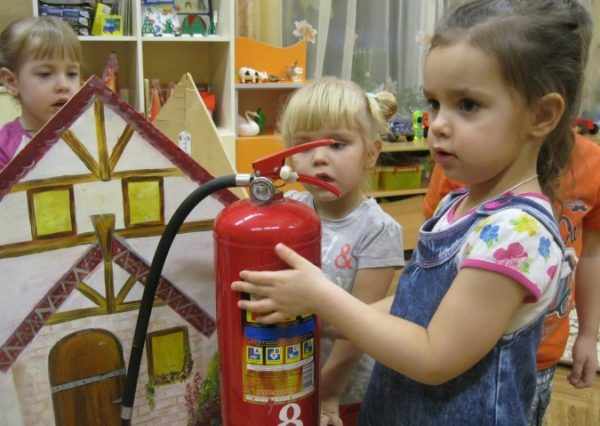 Girl holding a fire extinguisher