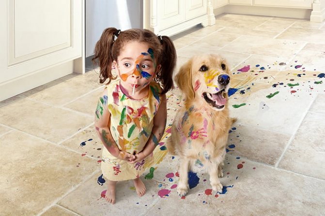 The girl and the dog got dirty with paints