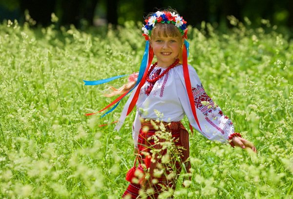 Girl in Russian costume in a field