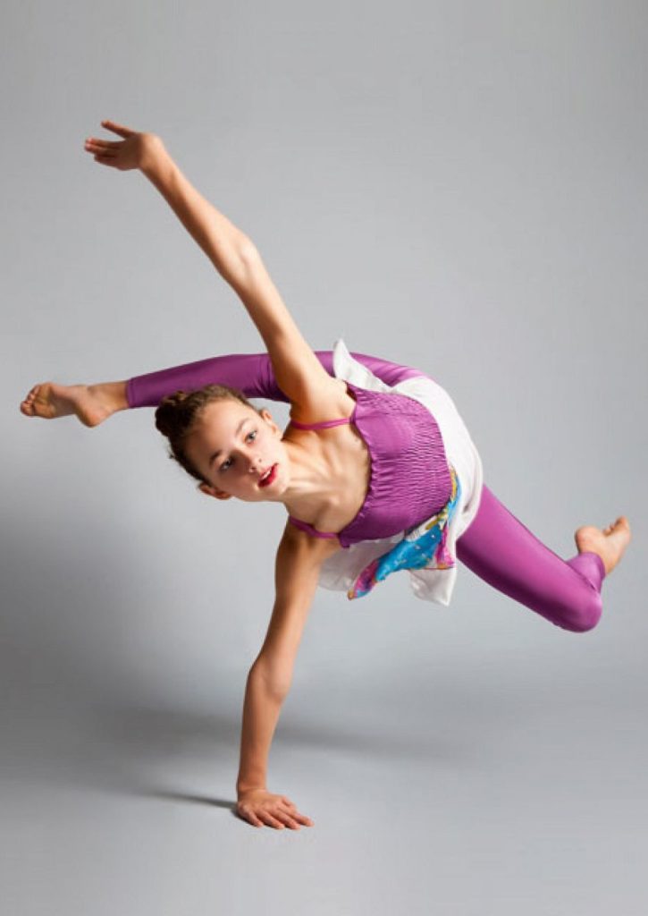 A girl performs a complex dance element