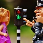 girl doll, policeman doll and traffic light