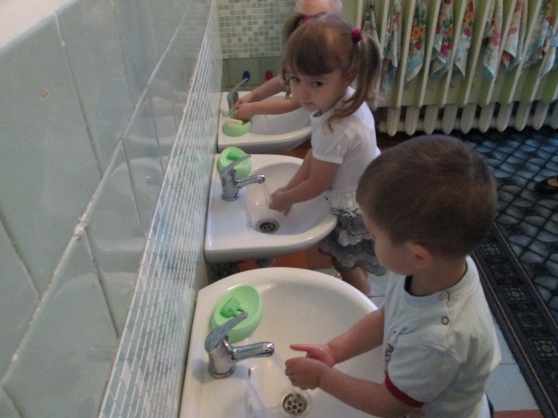 Boy and girl washing their hands