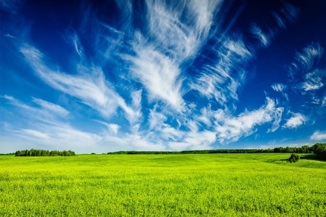 Green field, blue sky, white clouds
